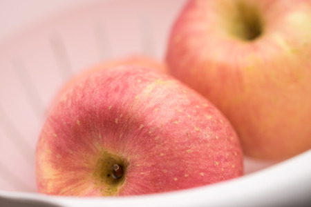 Close up of red apples in white basketの写真素材