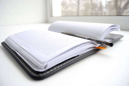 Open notebook with the handle, on white background.の写真素材