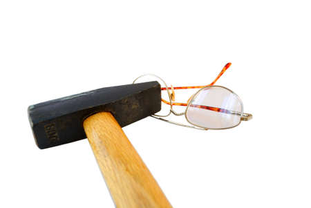 Heavy hammer and the broken glasses on a white background.の写真素材