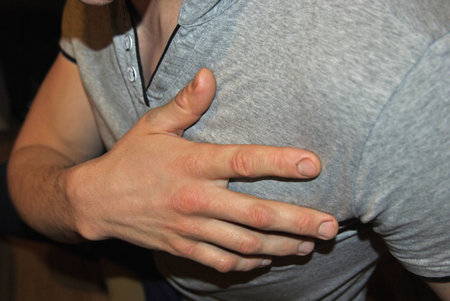 Young man having a heart attack