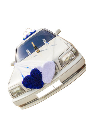 The white wedding car decorated with flowers on a white background.の写真素材