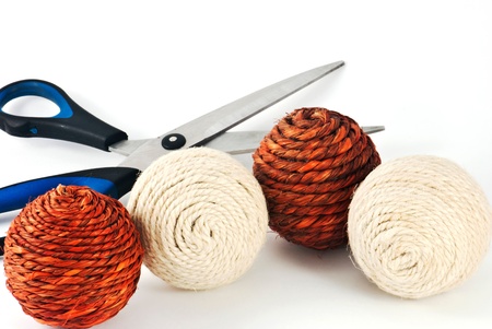 Four wool balls with scissors situated on the white backgroundの写真素材