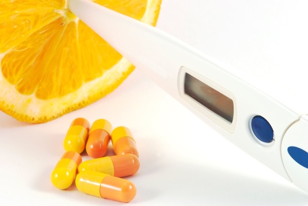 Orange fruit with vitamins and termometerの写真素材