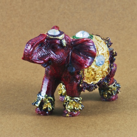 Small elephant model with reflection on beige backgroundの写真素材