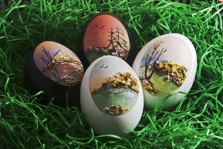 Hand-painted eggs on green grassの写真素材