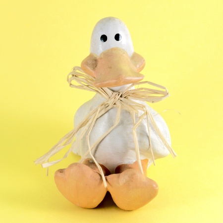 Easter duck on yellow backgroundの写真素材