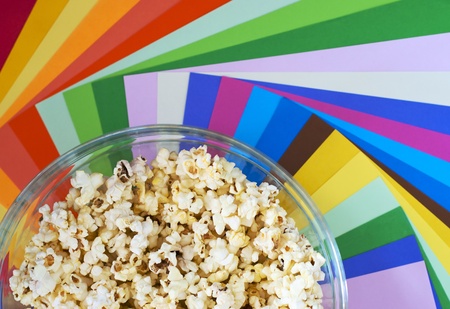 Popcorn in a bowl on colour backgroundの写真素材