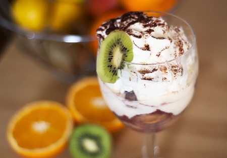 Sweet dessert with divers tropical fruit and whipped creamの写真素材