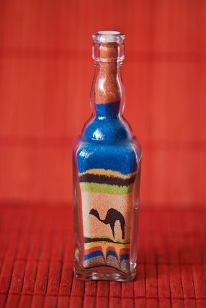 Decorative glass bottle with colourful sandの写真素材