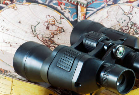 Binoculars on antique map with compassの写真素材