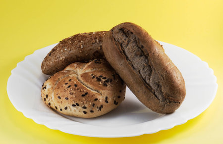 Wheat buns on yellow background