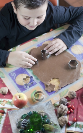 Little caucasian boy making christmas gingerbread cookiesの写真素材