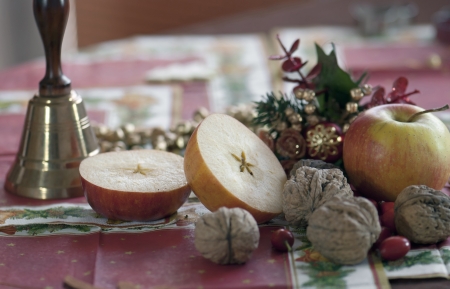 Christmas table, bell, apples and walnuts. Still life.の写真素材