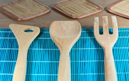 Wooden kitchen tools on a blue decorationの写真素材