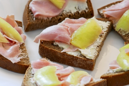 Buttered bread with ham and peppersの写真素材