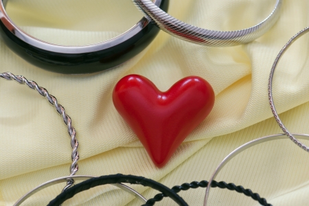 Small red heart with various bracelets.の写真素材