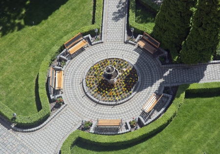 Wooden benches in the flowering garden. View from above.の写真素材