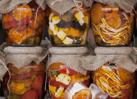 Feta cheese and olives in a jars - theme background.の写真素材