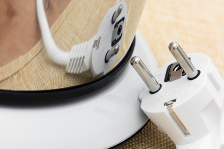 Mirror reflection of electrical plug. Detail of a electric tea kettle.の写真素材