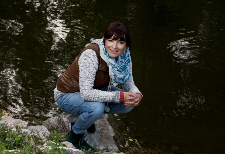 Young caucasian woman posing near evening lake.の写真素材
