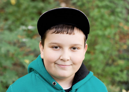 Young caucasian boy wearing baseball cap.