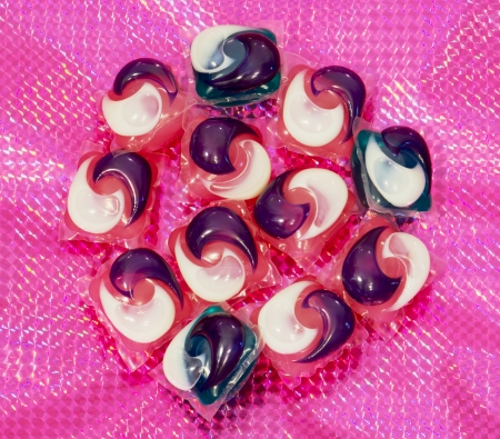Gel capsules for washing machine on a purple background.の写真素材