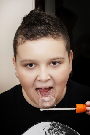 Young joyful boy with soap bubble.の写真素材