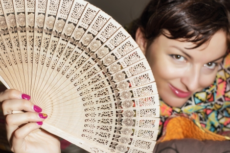 Joyful caucasian woman with a traditional fan.の写真素材