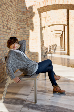 Woman in love posing on a bench. Beautiful light and shadows. Woman in love posing on a bench. Beautiful light and shadows.