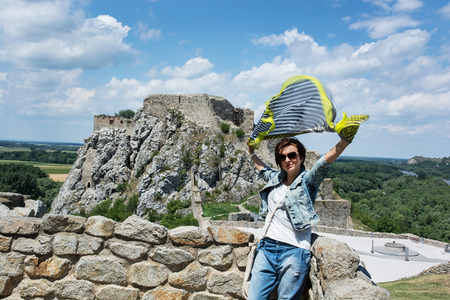 Beautiful woman with fluttering scarf on Devin castle. Slovakia, central Europe. の写真素材