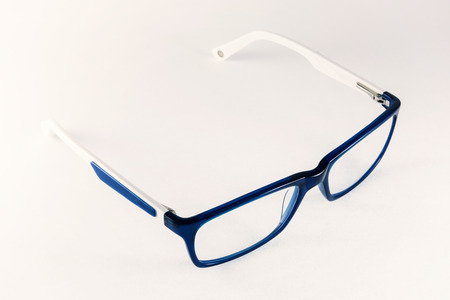 Blue-white women eyeglasses on a white background.の写真素材