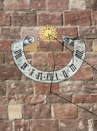 Beautiful historic sundial on the stone wall.の写真素材