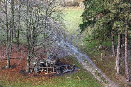 Old wooden shelter under deciduous trees and path in winter nature. Outdoors theme.の写真素材