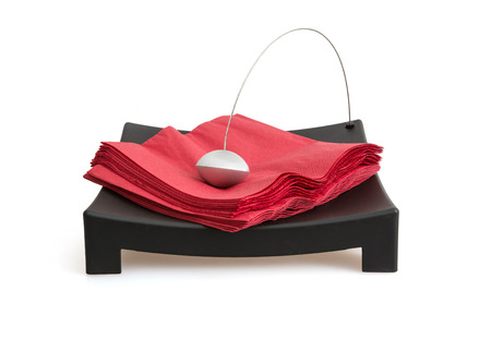 Napkin holder with paperweight on a white background.の写真素材
