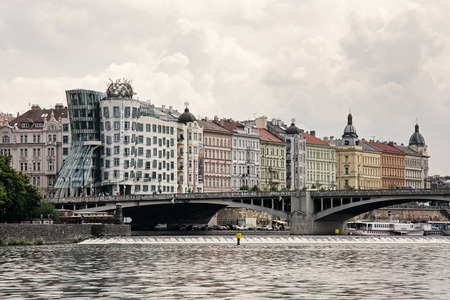 Dancing house and Jiraskuv bridge in Prague city, Czech republic, Europe.の写真素材