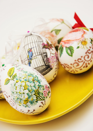 Decorated Easter eggs on the yellow plate. Spring time.の写真素材