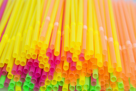 Background of plastic colored drinking straws.