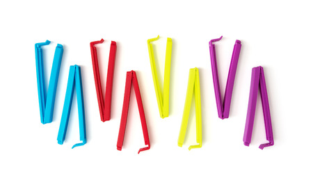 Various colorful bag clips on the white background.の写真素材