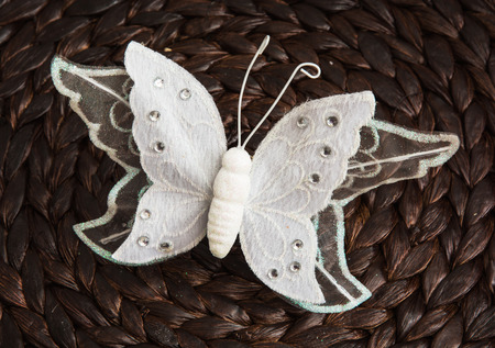 Handmade white butterfly on the dark background.の写真素材