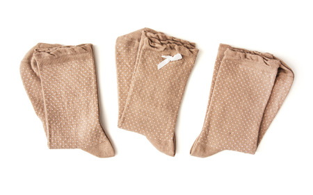 Three pairs of brown wool socks on the white background.の写真素材