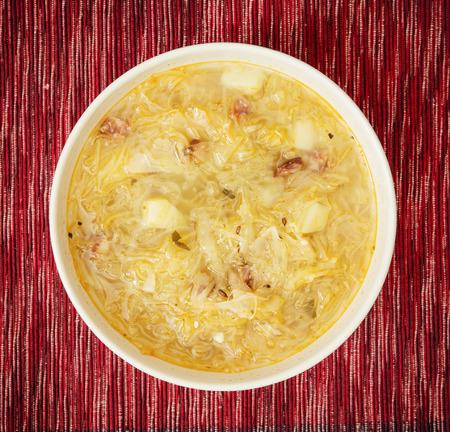 Cabbage soup on the red sheet.の写真素材