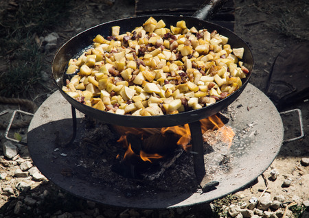 Delicate fried bacon with apples on metal pan. Food theme.の写真素材
