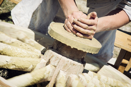 Potter works manually on the pottery wheel.の写真素材
