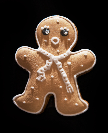 Tasty gingerbread man on the dark background. Christmas theme.の写真素材