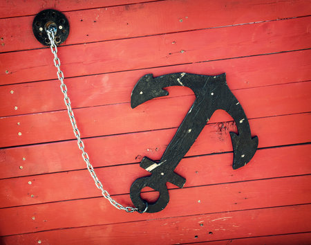 Retro anchor on the red boat. Sailing theme.の写真素材