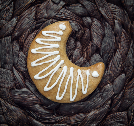 Tasty gingerbread moon on the dark background. Christmas theme.の写真素材