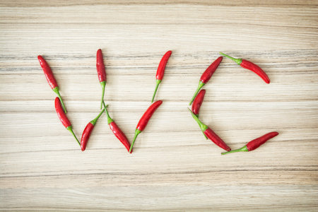 Chili peppers WC sign on the wooden background.の写真素材