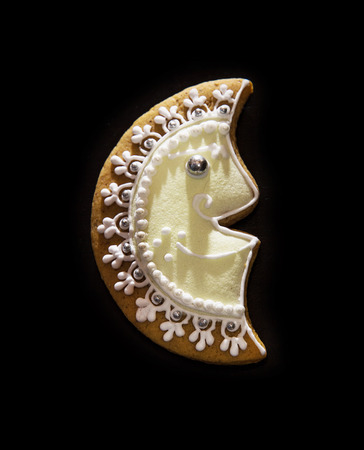 Tasty gingerbread moon on the dark background. Christmas theme. Bakery.の写真素材