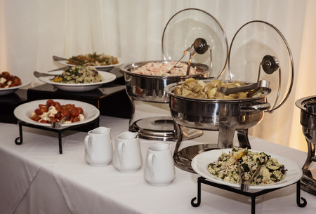 Catering boxes full of delicious food on wedding tables.の写真素材