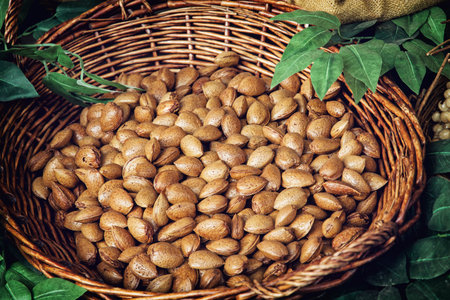 Closeup photo of almonds in wicker bowl. Healthy food.